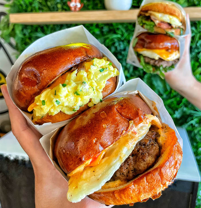 close up of a chicken breakfast sandwich and an egg breakfast sandwich